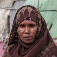 Student Hamda’s mother, Halima poses for a photograph near her home In the village of Abaar. Credit: GPE/AP